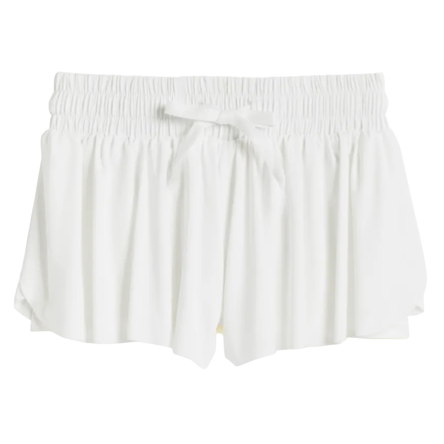 A pair of white shorts for girls, featuring a smocked waistband and a tie-bow detail.