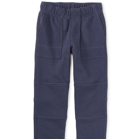 A pair of blue playwear pants for kids, featuring an elastic waistband, pockets, and reinforced knee areas.