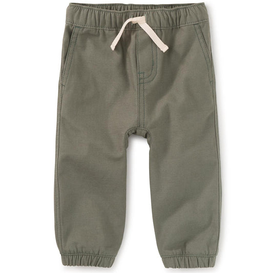 A pair of rosemary green cotton joggers for baby boys with a drawcord waist and a back patch pocket.