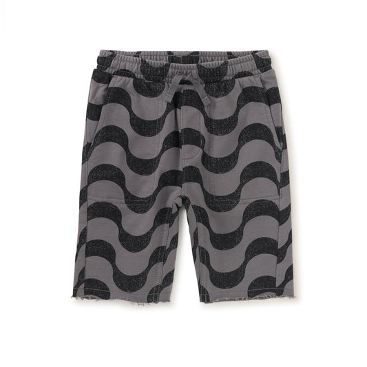Knee-length boys' shorts with a geometric wave pattern in black and gray, featuring an elastic waistband with a functional drawcord, and patch pockets.