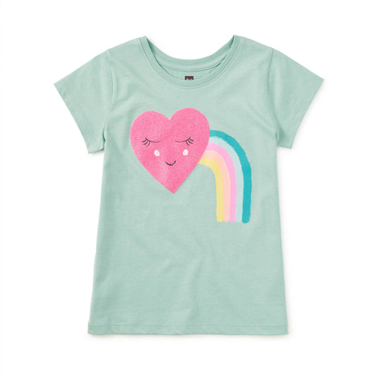 Light green t-shirt with a heart and rainbow design on a white background