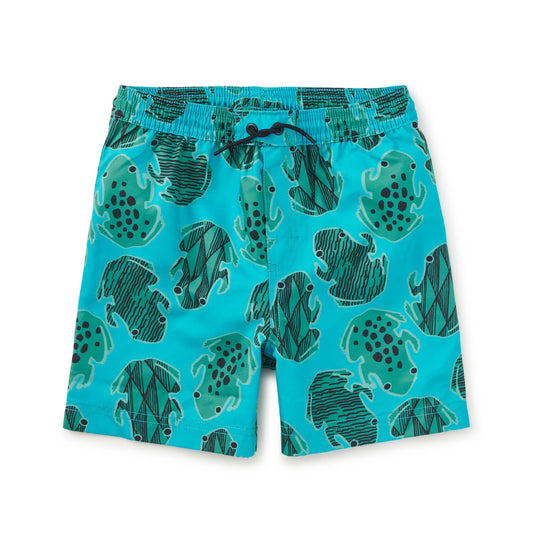 Blue swim shorts with green frog pattern on a white background