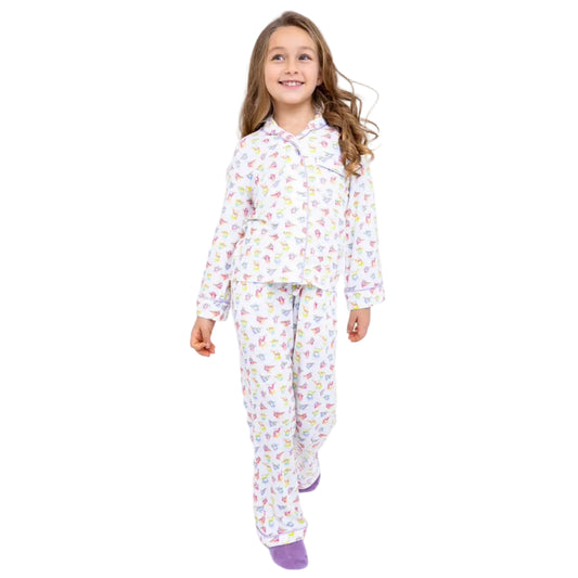 Young girl wearing a floral pajama set on a white background
