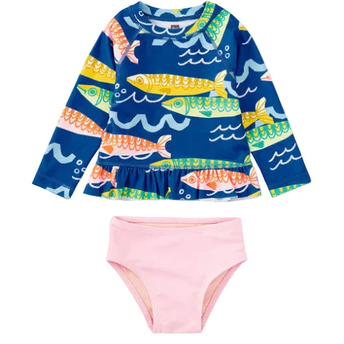 Children's swim set with fish patterned top and pink bottom on a white background