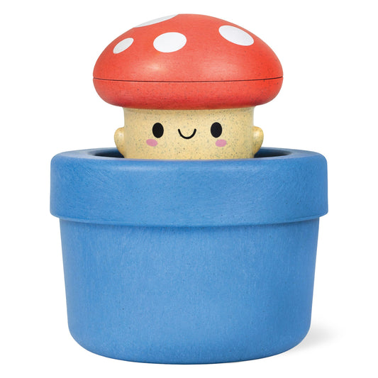 Toy mushroom with a blue pot on a white background