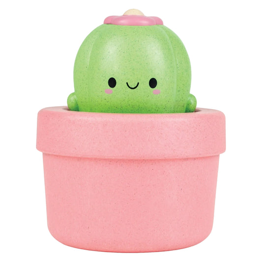 Cute green cactus toy in a pink pot on a white background
