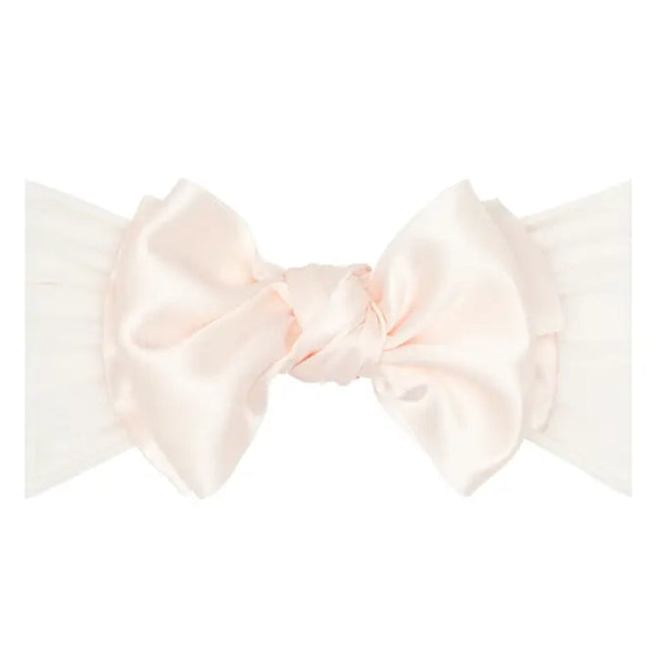 Light pink satin ribbon tied in a bow