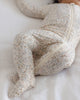 Baby wearing the Bloom Bamboo Zip Footie, lifestyle photo