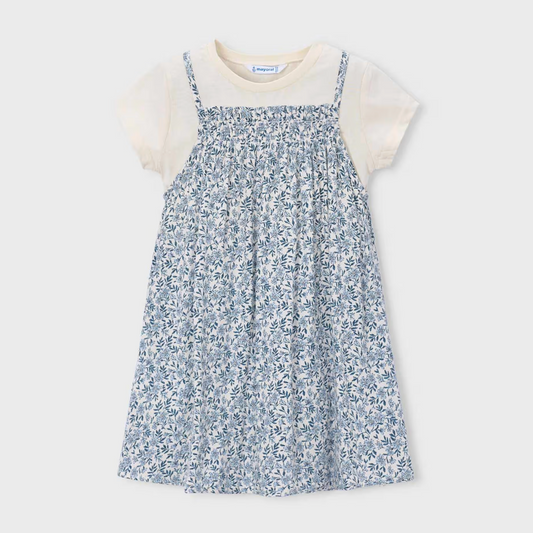 Children's dress with blue floral pattern layered over a white tee