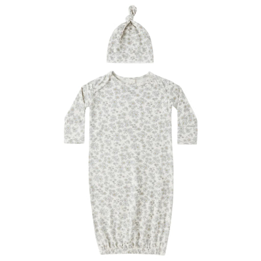 Baby gown and hat set with floral pattern on a white background