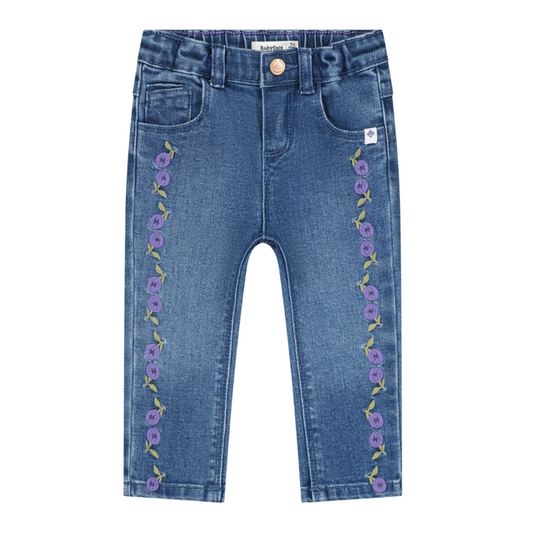 A pair of blue denim cropped pants for kids, featuring purple floral embroidery running down both sides of the legs, displayed on a solid white background.