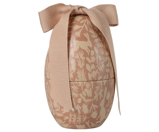 Decorative Easter egg with floral patterns and a bow on a white background