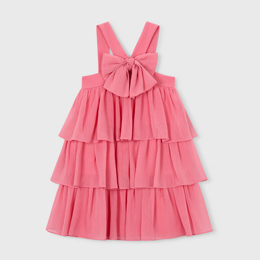 Coral pink tiered dress with halter straps and bow at the chest.