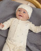 Baby wearing the Celestial Ribbed Romper, lifestyle photo