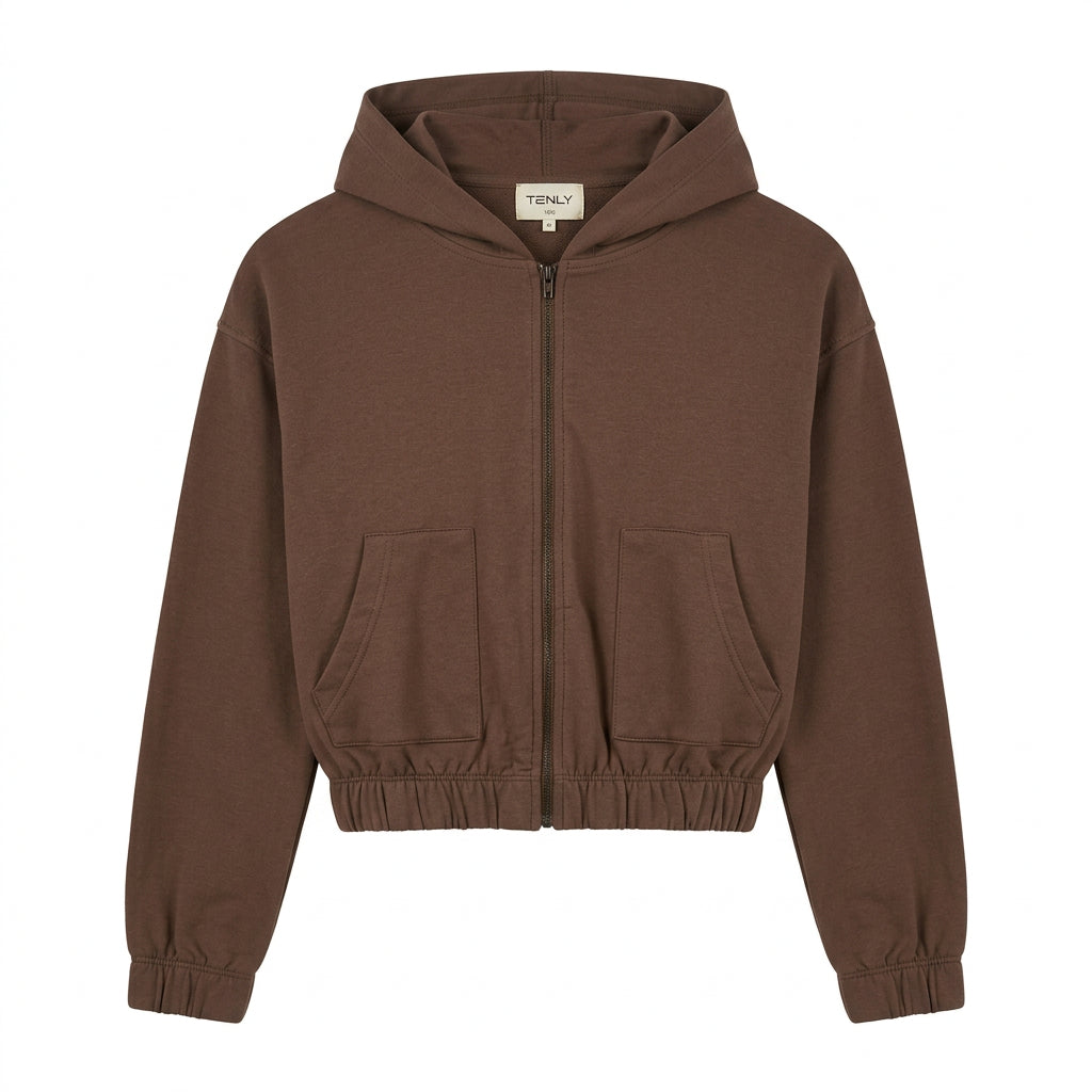 A brown zip-up hoodie sweatshirt with a high collar and elastic cuffs, hanging on a white hanger against a plain white wall.