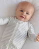 Baby wearing the Cloud Stripe Zip Footie by Quincy Mae, lifestyle photo