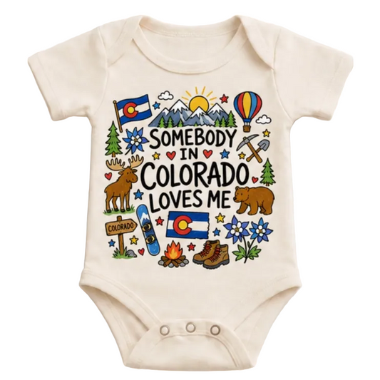 Baby onesie with Colorado-themed graphics and text on a white background