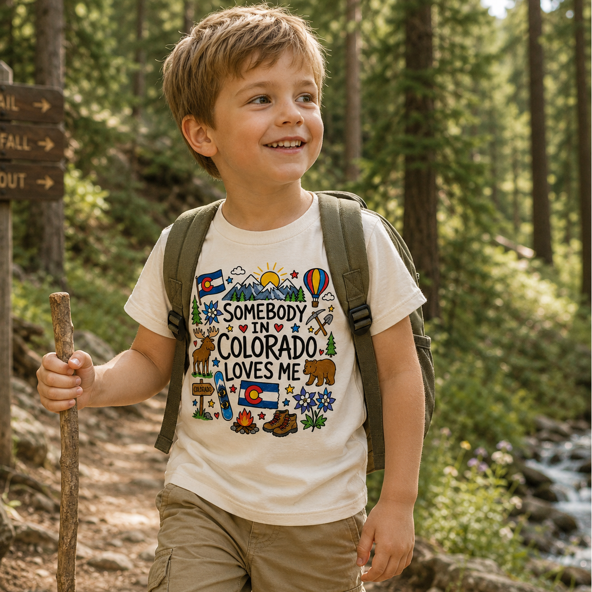 child wearing offwhite tshirt with Colorado graphic that says "Somebody in Colorado Loves Me"