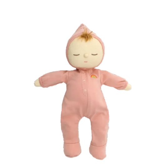 Plush baby doll in a pink outfit on a white background