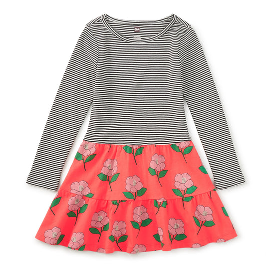 Two-tone dress with striped top and floral skirt on a white background
