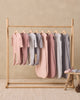 Baby wearing the Dusty Rose Bamboo Zip Footie, lifestyle photo