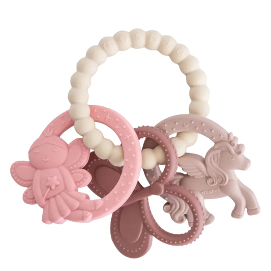 Set of pink and beige baby teething rings on a white background