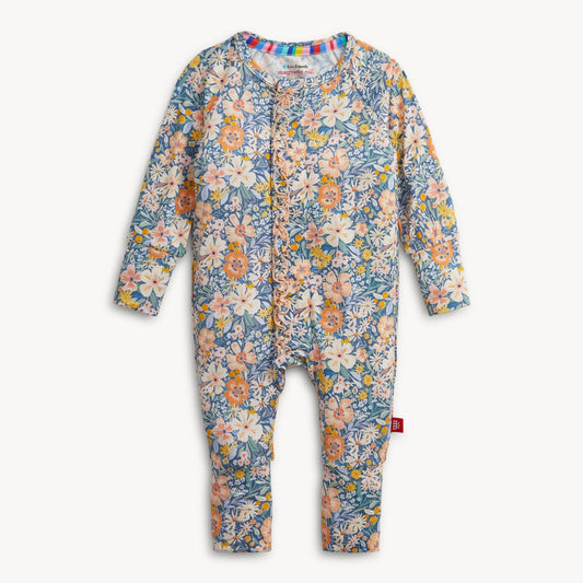 A baby long-sleeve footless one-piece romper with an all-over floral print in blue, pink, orange, and cream, featuring a snap-button front closure and a small red tag on the leg.