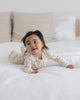 Baby wearing the Floral Vine Zip Footie by Quincy Mae, lifestyle photo