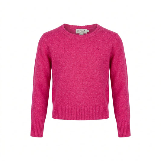 A bright pink cropped knit sweater with long sleeves,