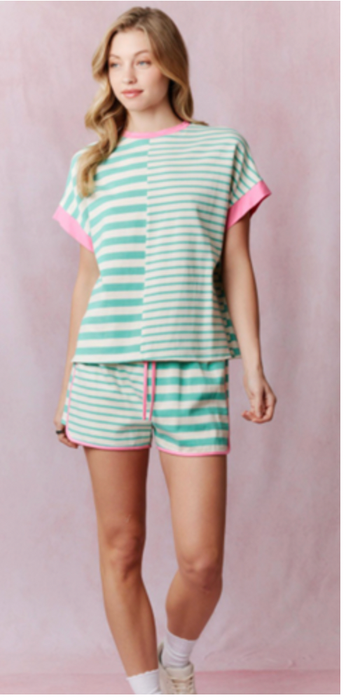 Girl wearing a striped green pair of shorts with pink accents