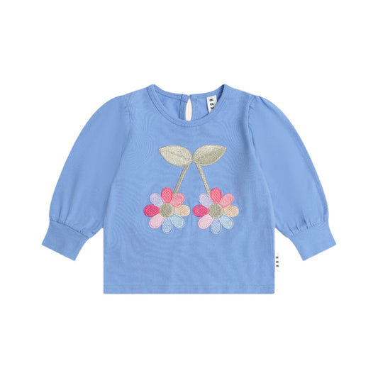 Blue long-sleeve shirt with floral design on a white background