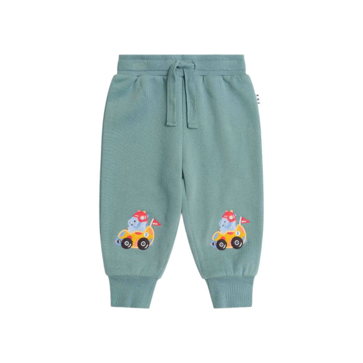 Light blue sweatpants with cartoon character on a beige background