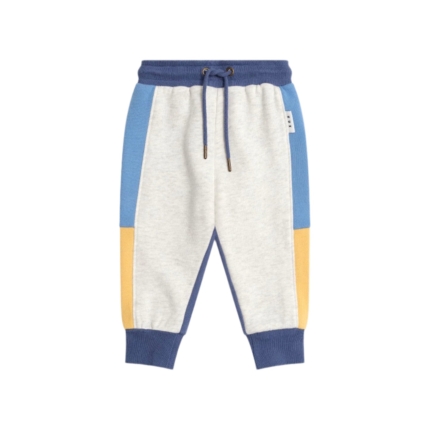 Color-blocked sweatpants with blue and yellow accents on a light pink background