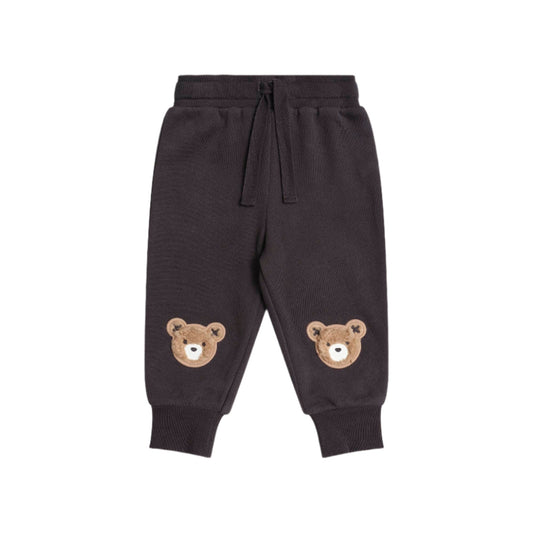 Dark gray sweatpants with bear face designs on a white background