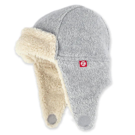 Gray winter hat with beige earflaps on a white background