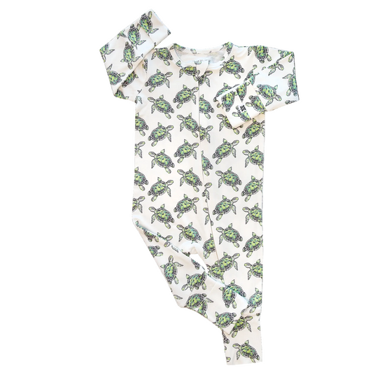 Baby onesie and headband with turtle pattern on a white background