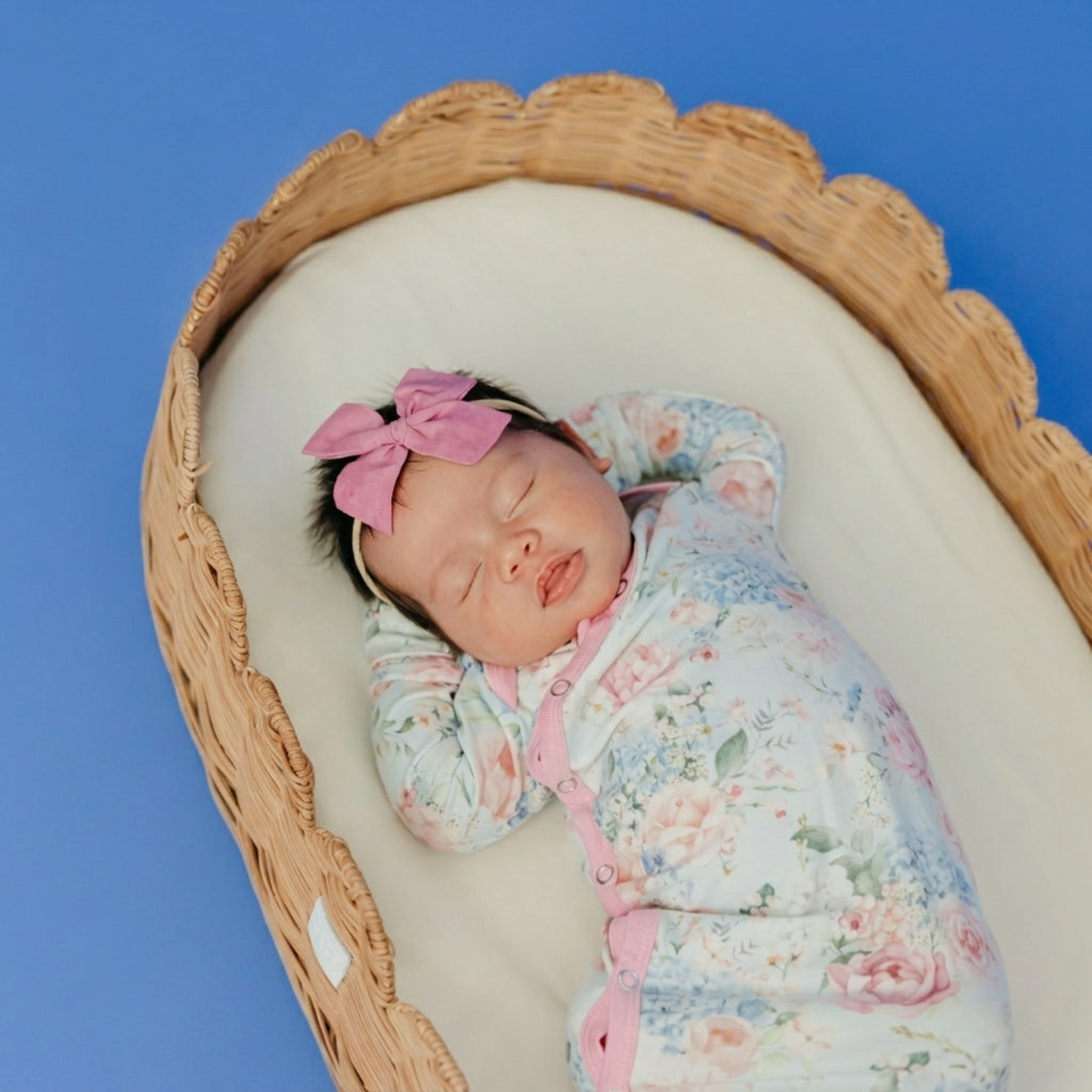 Floral baby knotted gown with pink trim and snaps