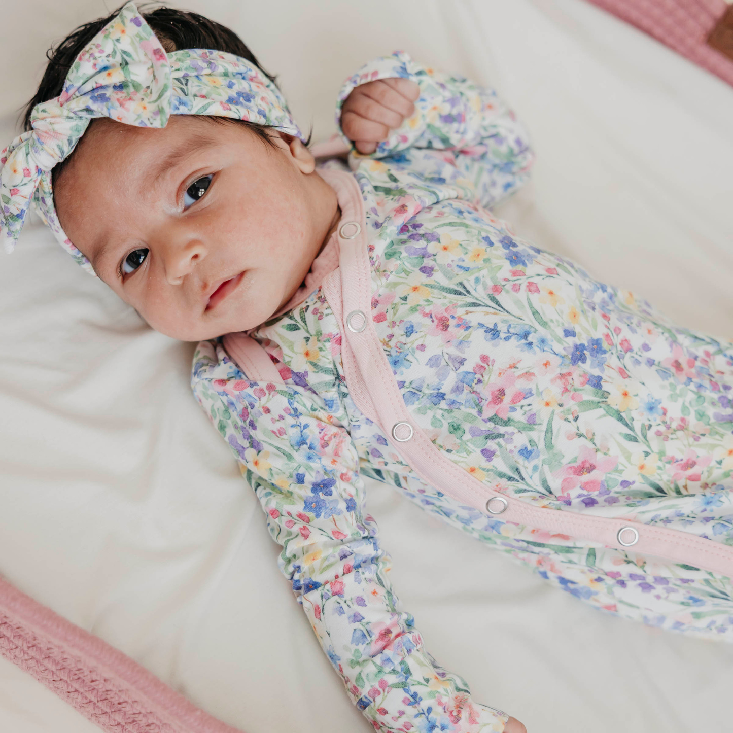 Floral baby knotted gown with pink trim and snaps