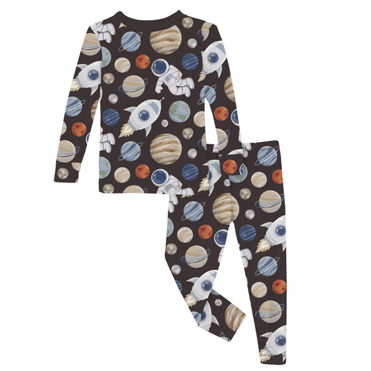 A 2-piece pajama set with a space theme, featuring planets and an astronaut on a dark background.