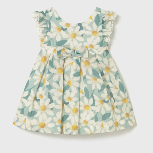 Floral dress with white flowers and green leaves on a light gray background