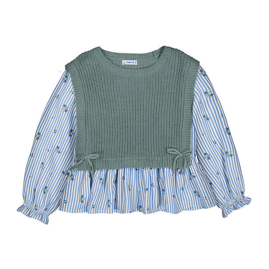 A children's long-sleeve blouse featuring a sage green ribbed knit vest bodice layered over a light blue and white striped floral print skirt, with ruffled cuffs and side bows.
