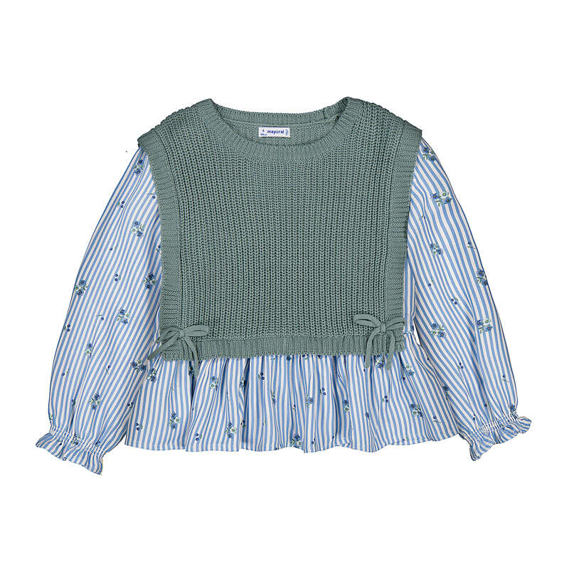 A children's long-sleeve blouse featuring a sage green ribbed knit vest bodice layered over a light blue and white striped floral print skirt, with ruffled cuffs and side bows.