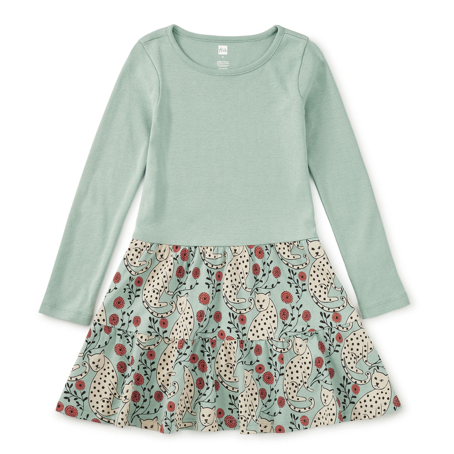 Green long-sleeve top with a patterned skirt on a white background