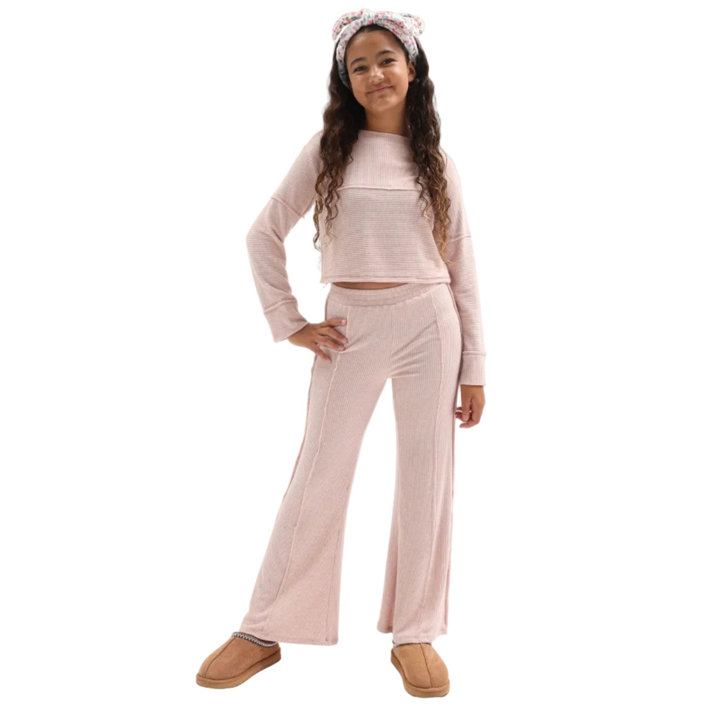 Young girl wearing a light pink top and pants