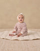 Baby wearing the Mulberry Stripe Henley Jumpsuit by Quincy Mae
