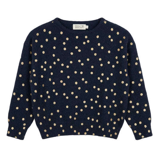 A navy blue cropped knit sweater with beige polka dots,