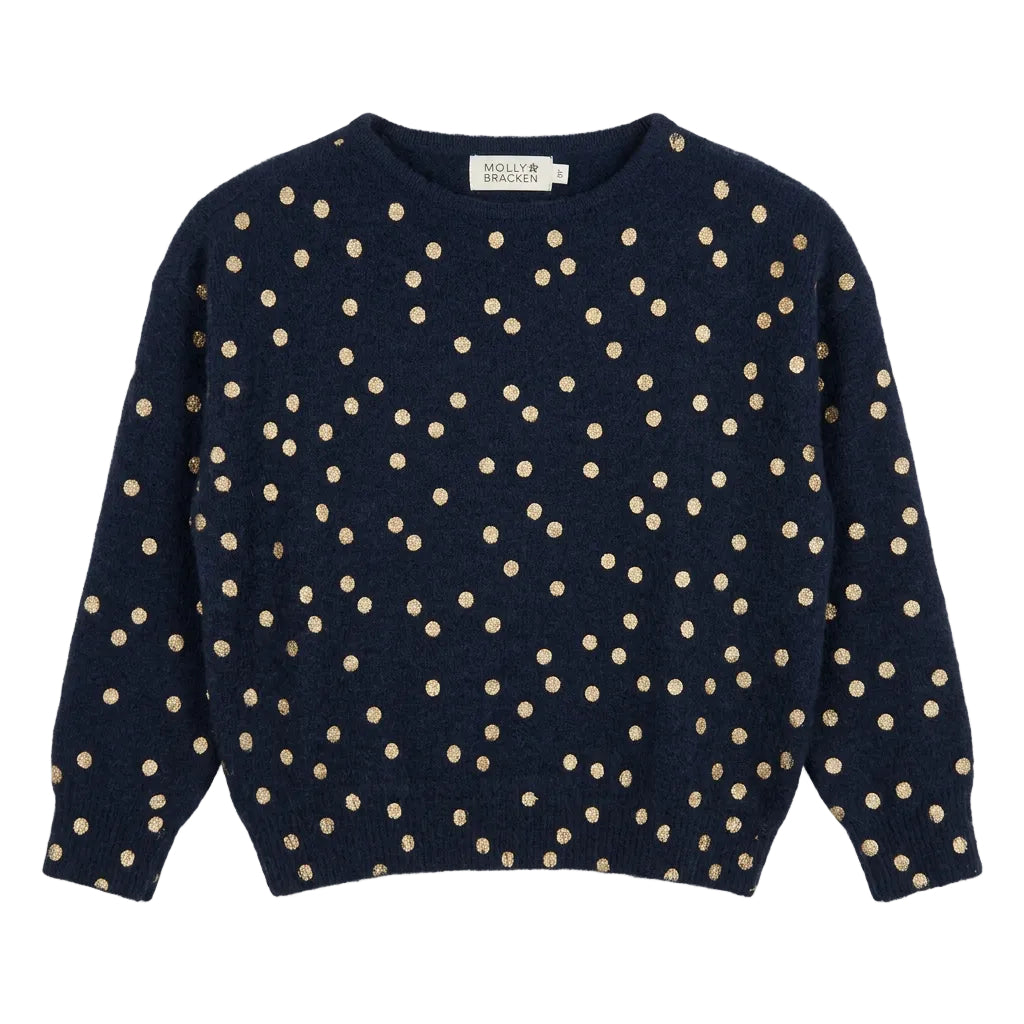 A navy blue cropped knit sweater with beige polka dots,