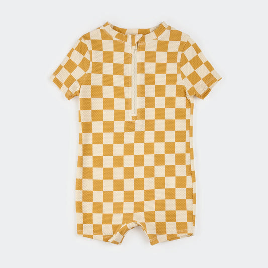 Quarter zip rash guard with mustard and cream colored checker board pattern