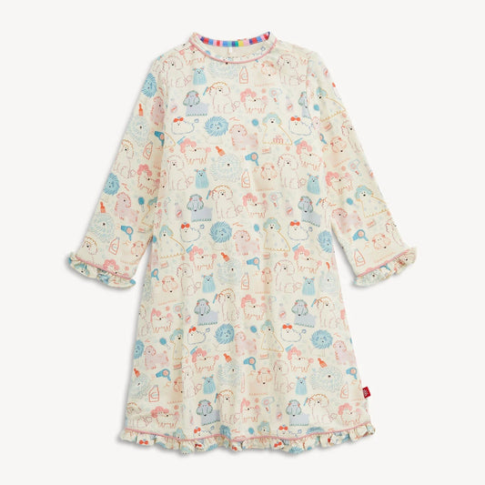A long-sleeve baby dress with a cream base and an all-over print of cute cartoon animals in pastel blue, pink, and orange. The dress features ruffled cuffs and a ruffled hem, and is shown against a plain light background.