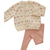 Children's cardigan with heart pattern and pink leggings on a light background